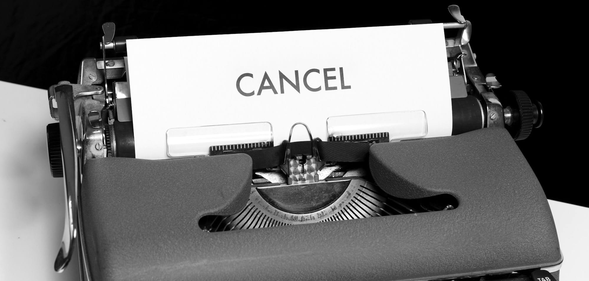 green and white typewriter on black textile